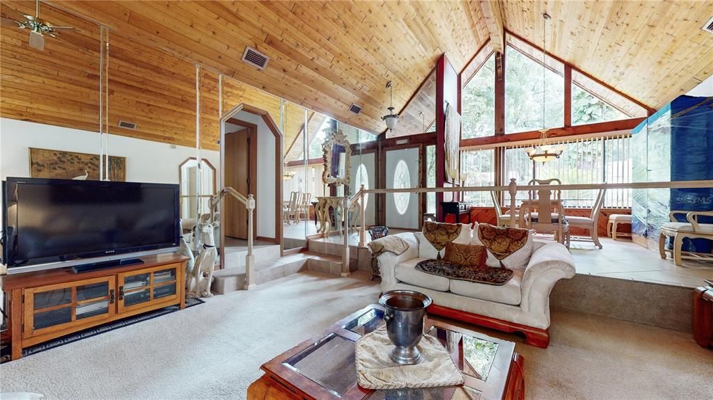 Living room with cabin style vaulted wood ceiling