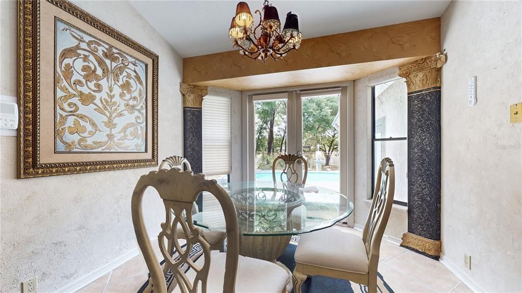Kitchen dinette area overlooks pool and view of lake.