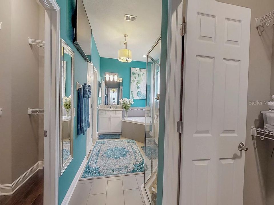 Master bath with both walk in closet doors open (left and right)