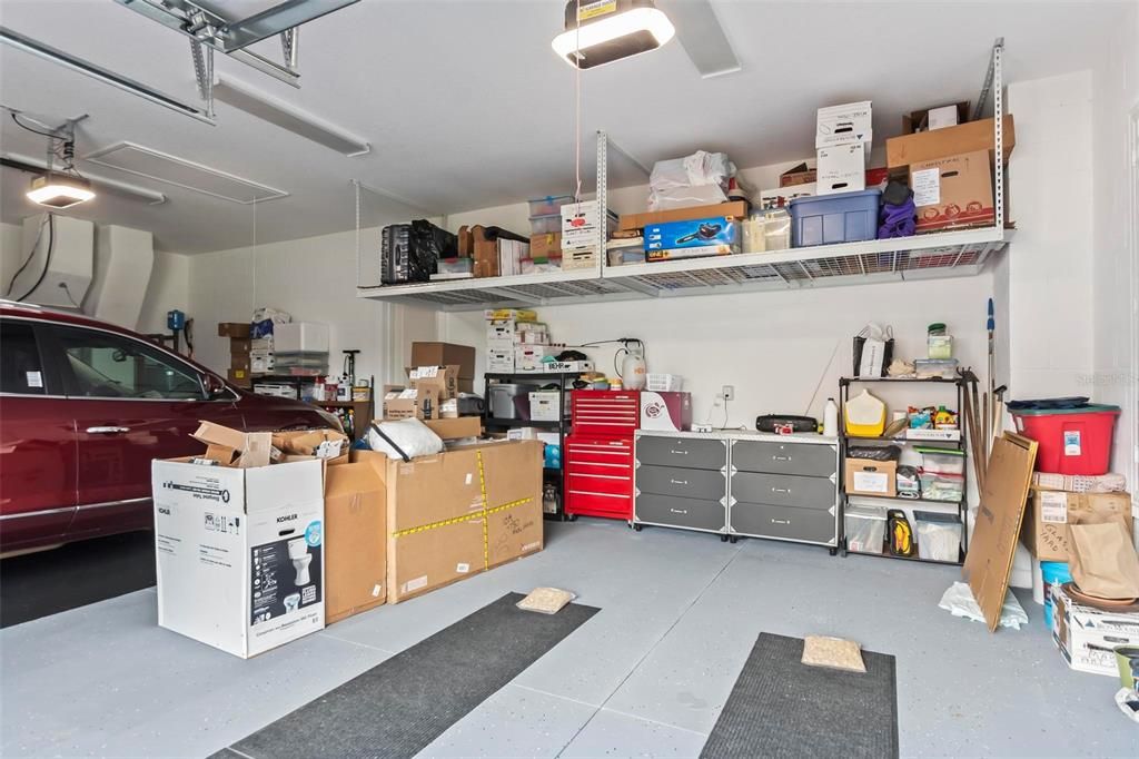 The three-car garage has storage racks for your convenience and epoxy flooring.