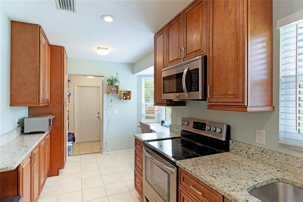 Behind the kitchen is your in-home washer/dryer and utility space, with access to the garage