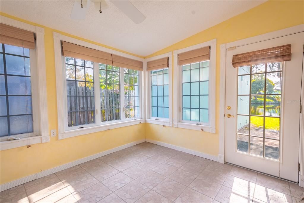 The office/Florida room has a decorative tile floor, a ceiling fan and access to the backyard.