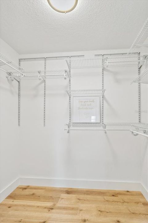Primary walk-in closet with configurable closet system