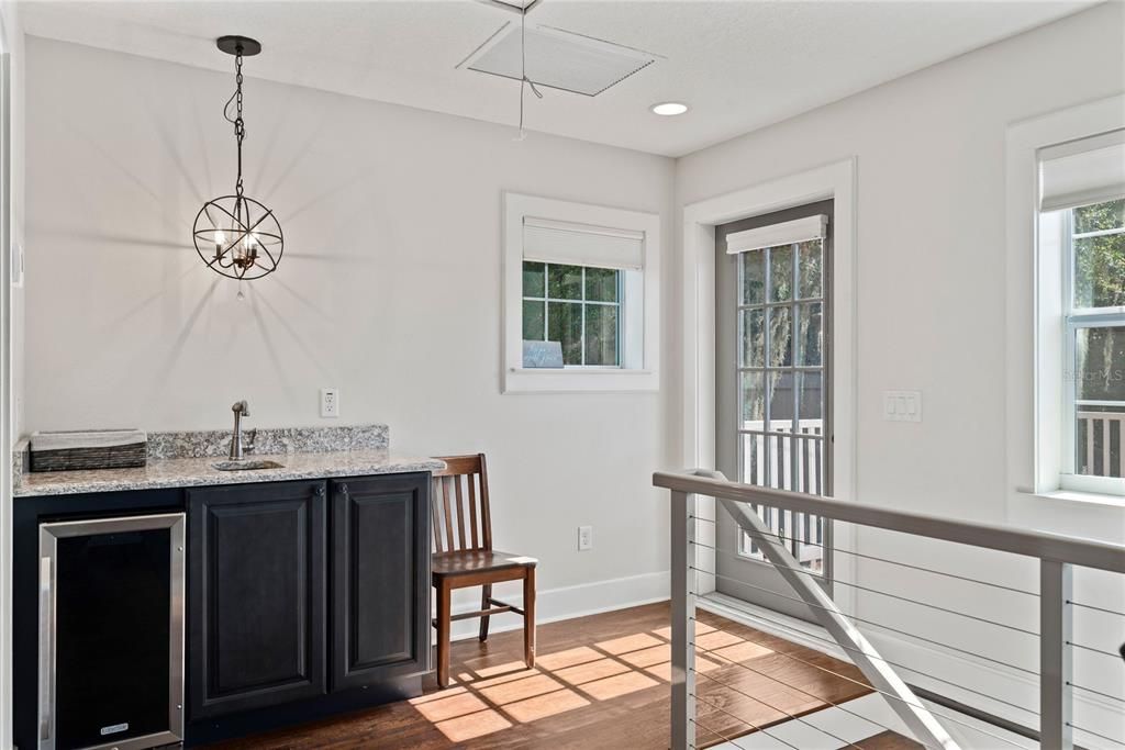 Guest house with a full bathroom, balcony and wet bar.