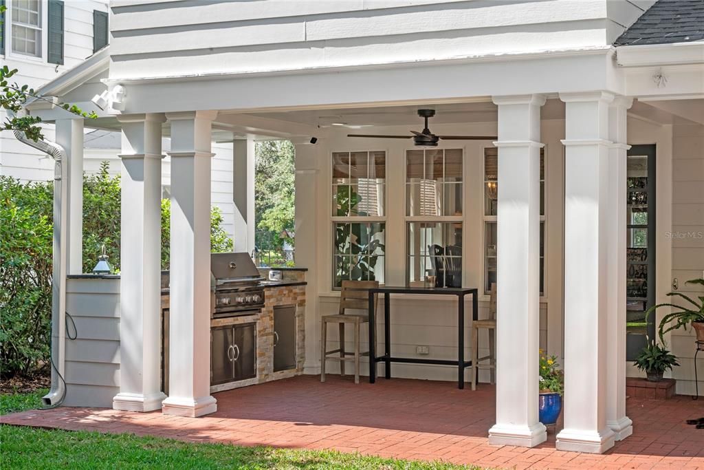 Outdoor kitchen with grill, sink and fridge