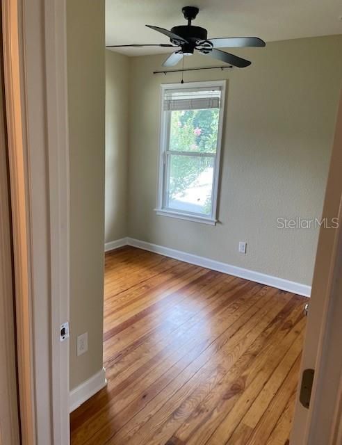 Bedroom 2 with hardwood flooring
