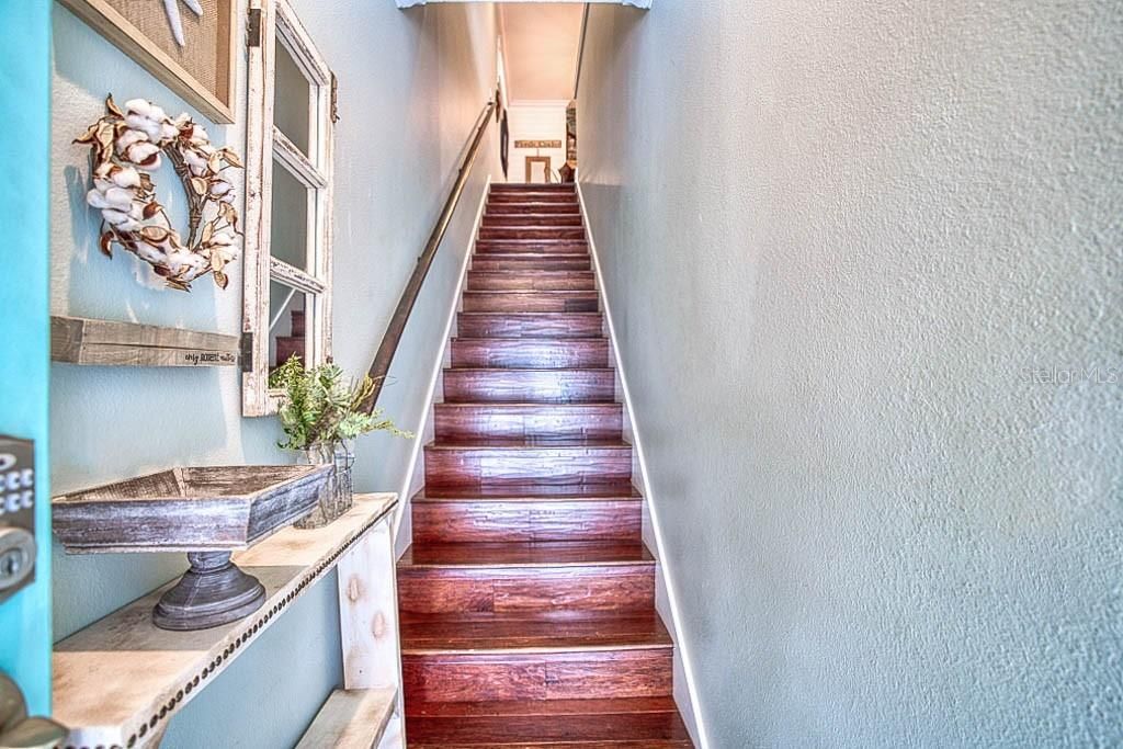 stairs from front door going up into main house first to second floor