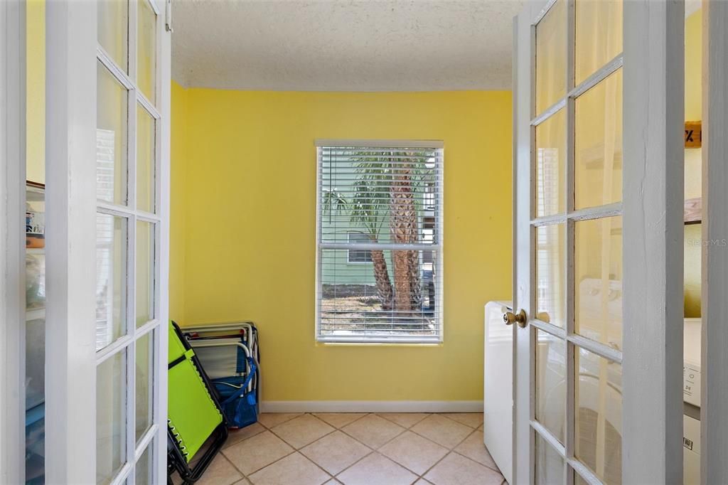 Through these French doors is laundry and extra storage!