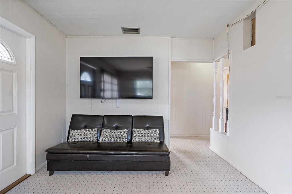 Living room with view to hallway and all three bedrooms.