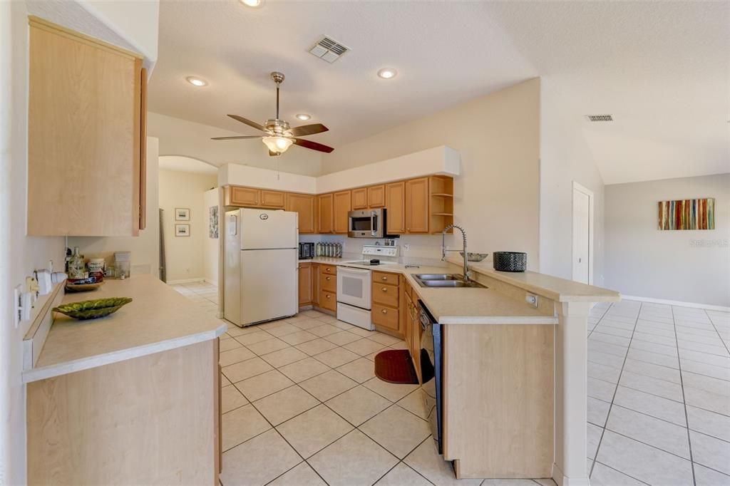 The kitchen is in the heart of it all with direct access to both delivering ample cabinet and counter space, closet pantry, plus a breakfast bar and breakfast nook for additional casual dining with a view of the lake!