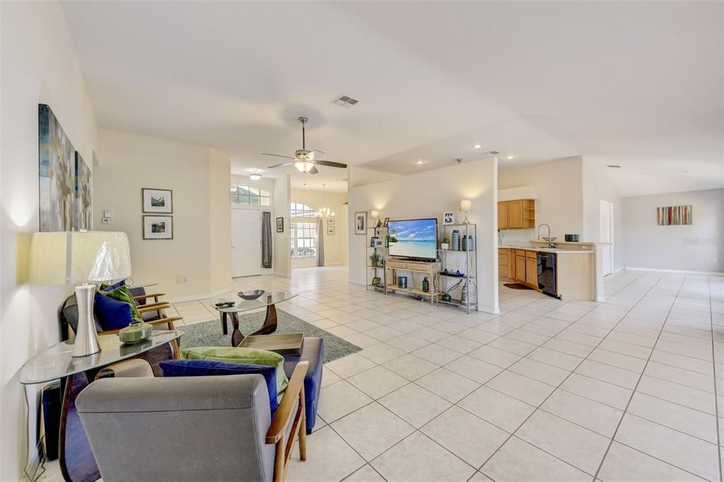 TILE FLOORS flow through all the main living areas for easy maintenance and the high ceilings and oversized sliding glass doors add to the light and bright feel of a formal dining area and spacious living room.