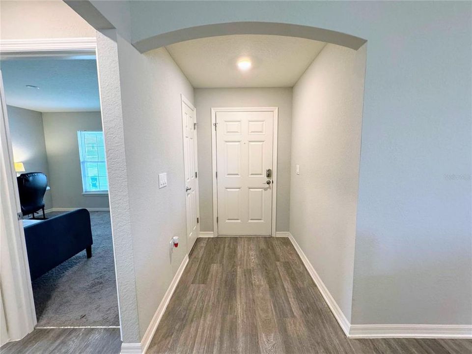 Entryway with coat closet and bedroom one