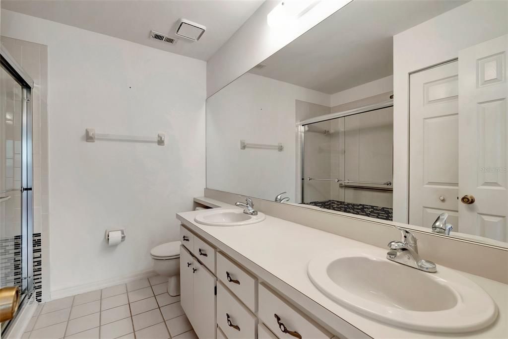 Spacious Primary Bedroom Ensuite with double sinks, newer shower and linen closet.