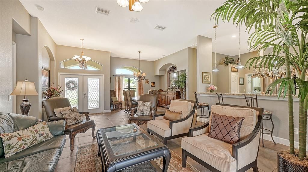 VIEW FROM FORMAL LIVING ROOM ONTO KITCHEN AND FORMAL DINING ROOM AREAS