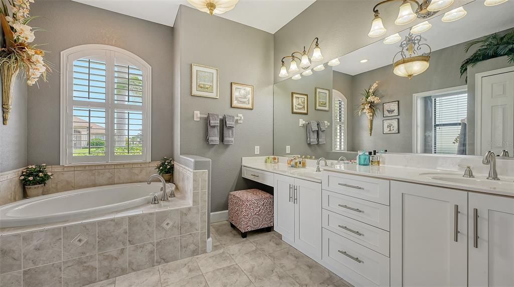 PRIMARY BATHROOM WITH DOUBLE SINKS AND VANITY AREA