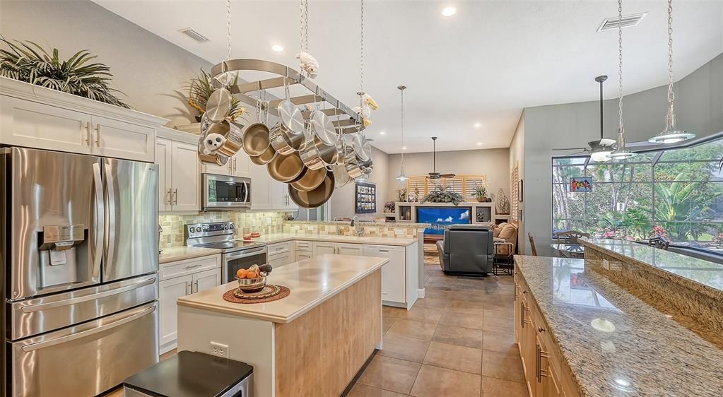 CUSTOM POT RACK AND KITCHEN HAS TWO EAT AT COUNTERS