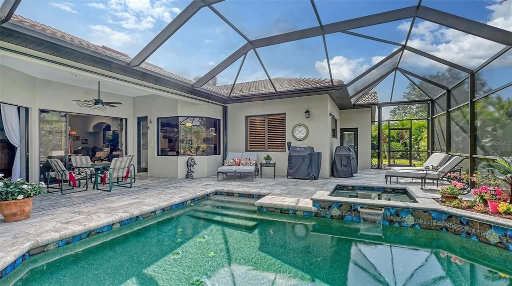 HEATED SALTWATER POOL WITH SPA AND EXTENDED LANAI WITH TRAVERTINE PAVERS