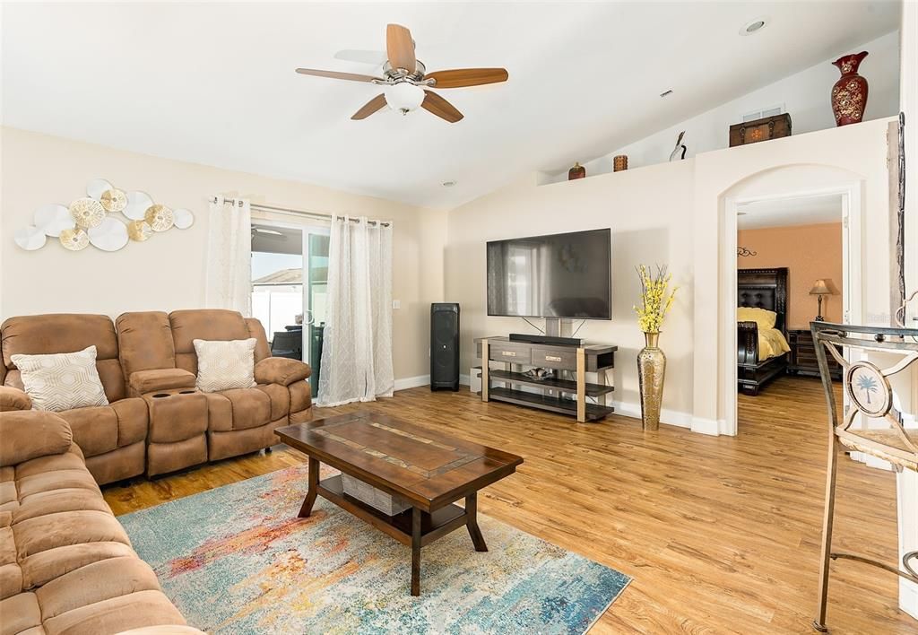 Spacious living area with access to the Kitchen Breakfast Bar & Outdoor lanai. Luxury Vinyl floors throughout.