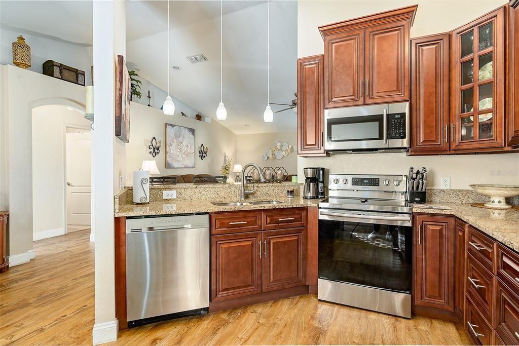 Beautiful Cherry finish on the solid wood cabinets, Stainless appliances less than 5 years old.