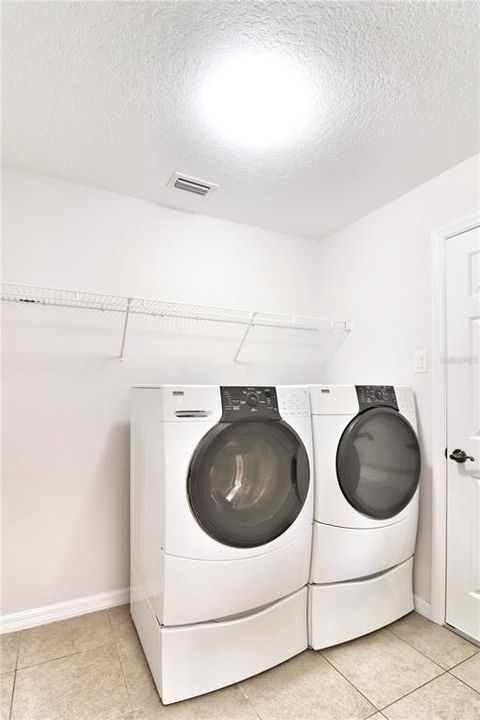 laundry room with HE washer and dryer