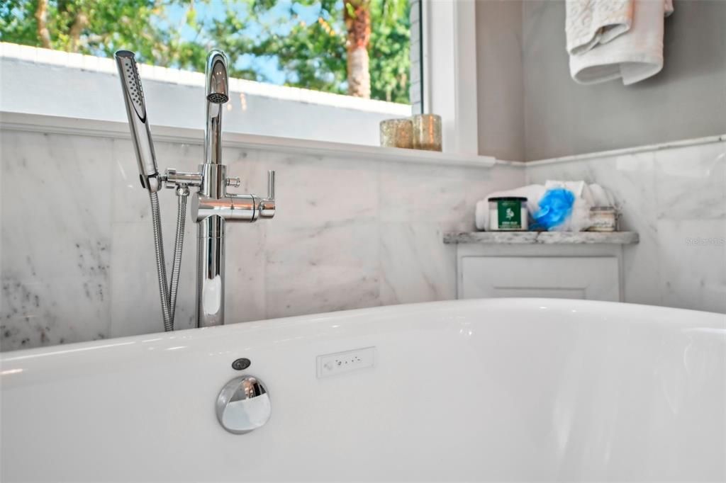 Enjoy soaking sore muscles in your private tub with gorgeous palm tree and courtyard view