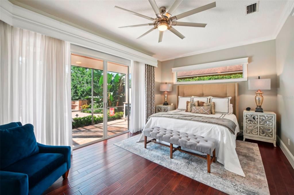 Master Bedroom includes slider doors  to covered lanai, crown  moulding, his/her walk in closets and ensuite