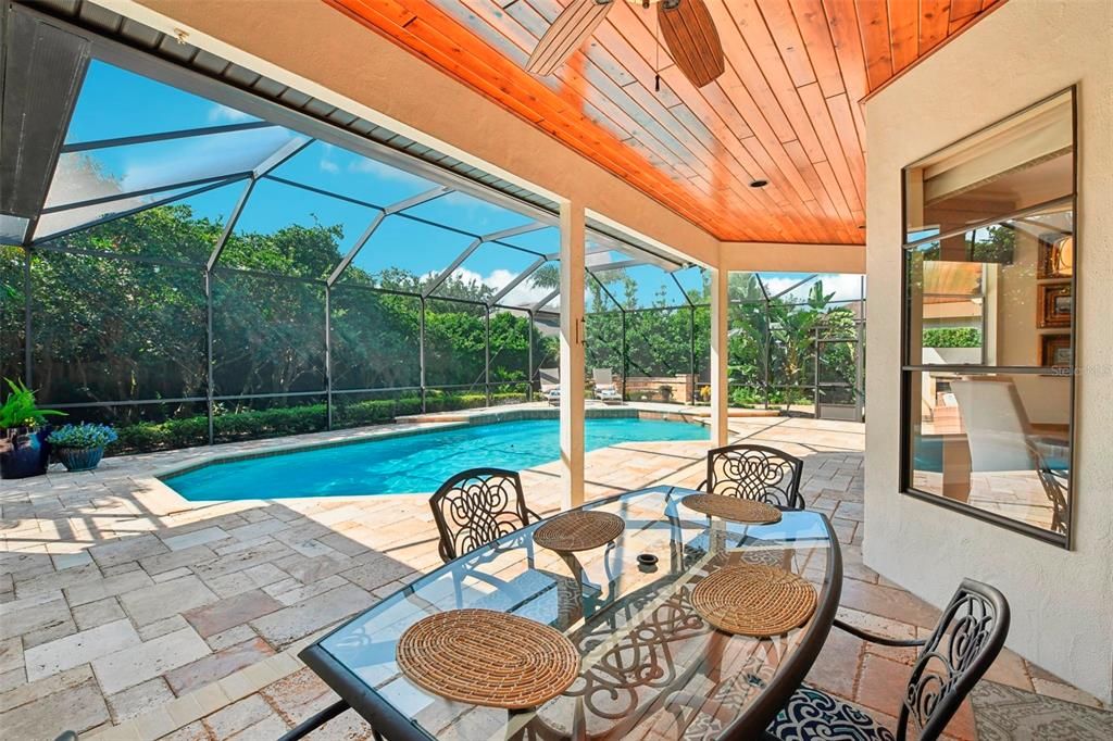 multiple sitting and dining areas under spacious lanai complete with tongue and groove ceiling