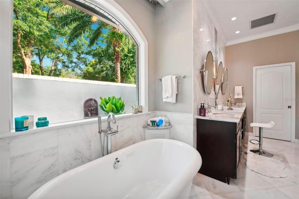 Freestanding Bubble Tub with view of private courtyard