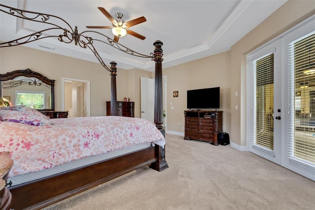 With "back-light" tray ceiling and glass french doors leading to the lanai and pool area.