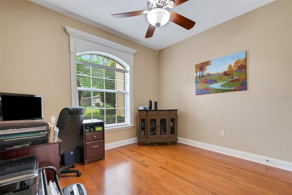 A large arched window beautifully accented by custom millwork.