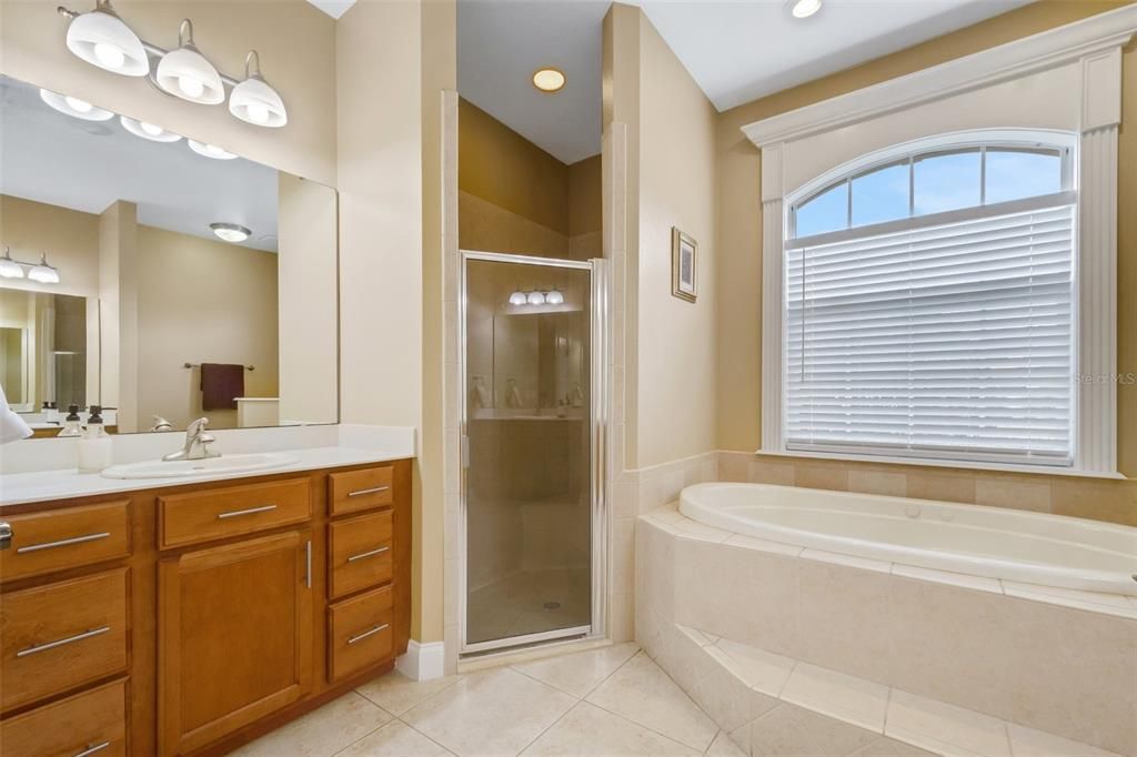 With dual vanities, a large jetted tub and fully tiled walk-in shower.