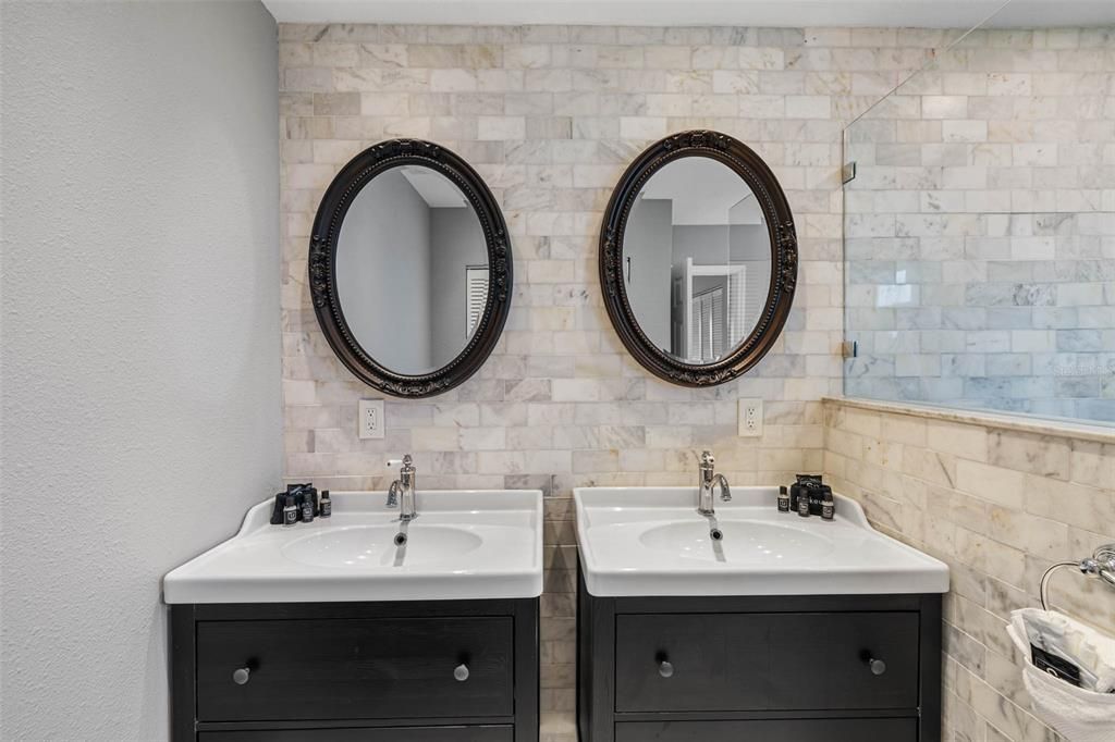 Primary suite bathroom with two vanities.
