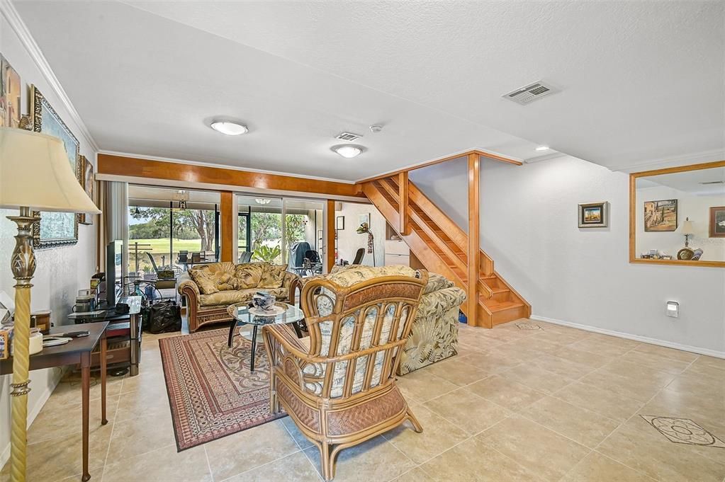 Family Room on 1st floor showing sliding glass doors to lanai and stairway to 2nd floor