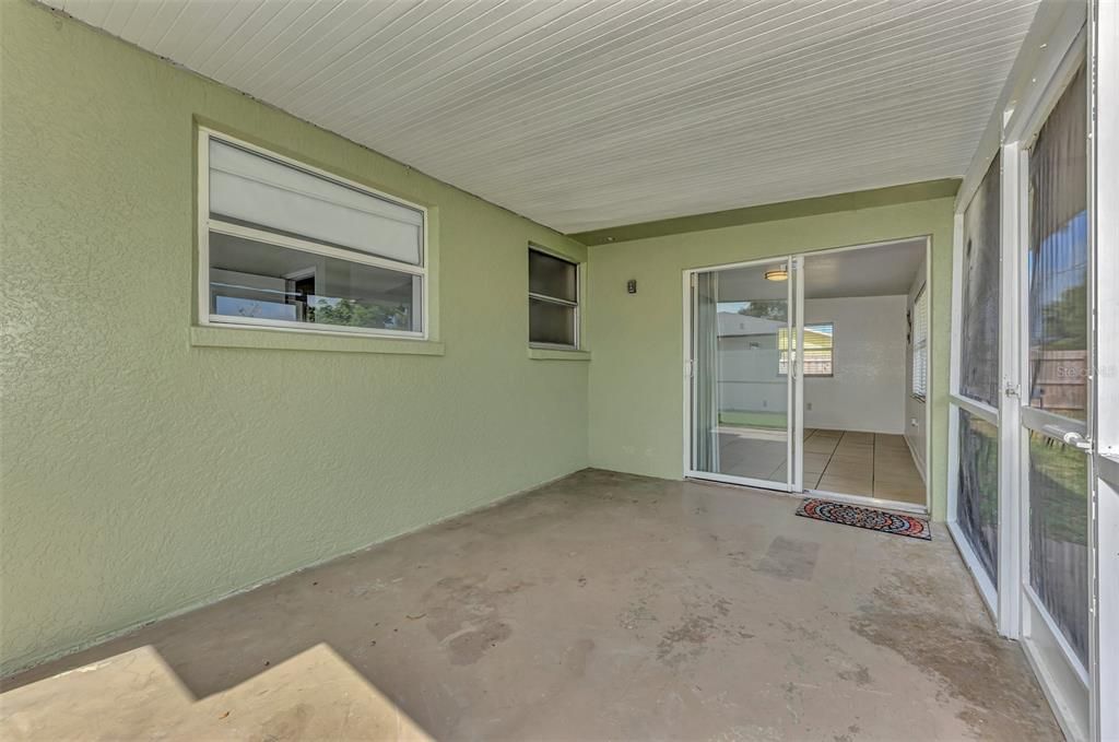 Enclosed Lanai, with sliders looking into the fully tiled Family Room/ Florida Room