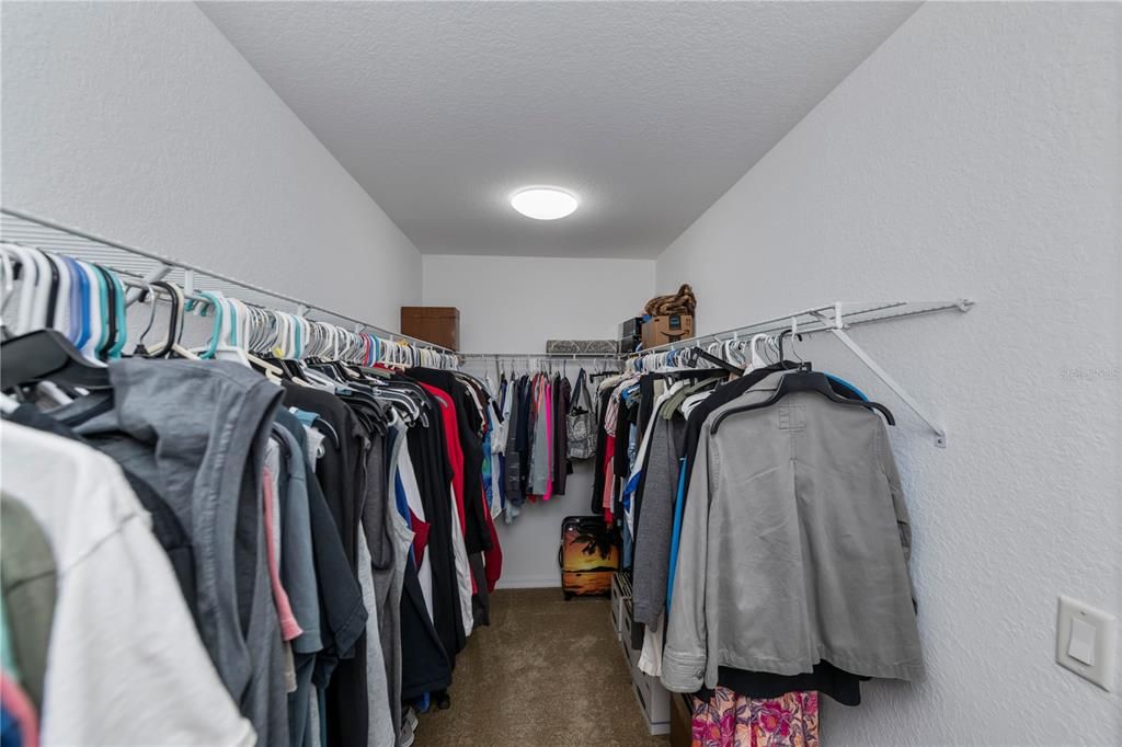 Primary bedroom walk in closet