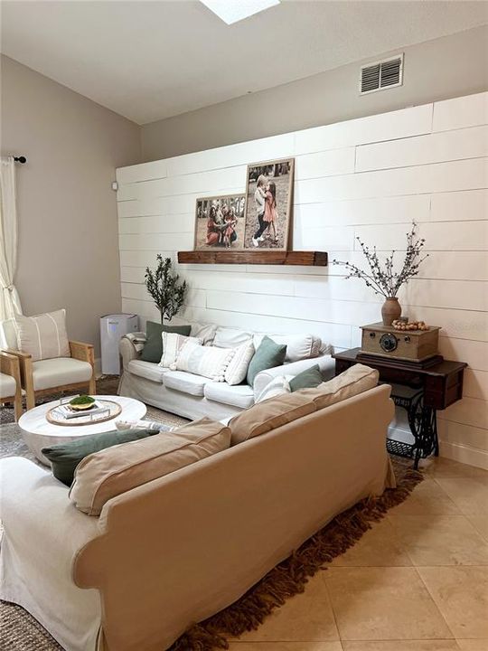 Family room featured shiplap wall