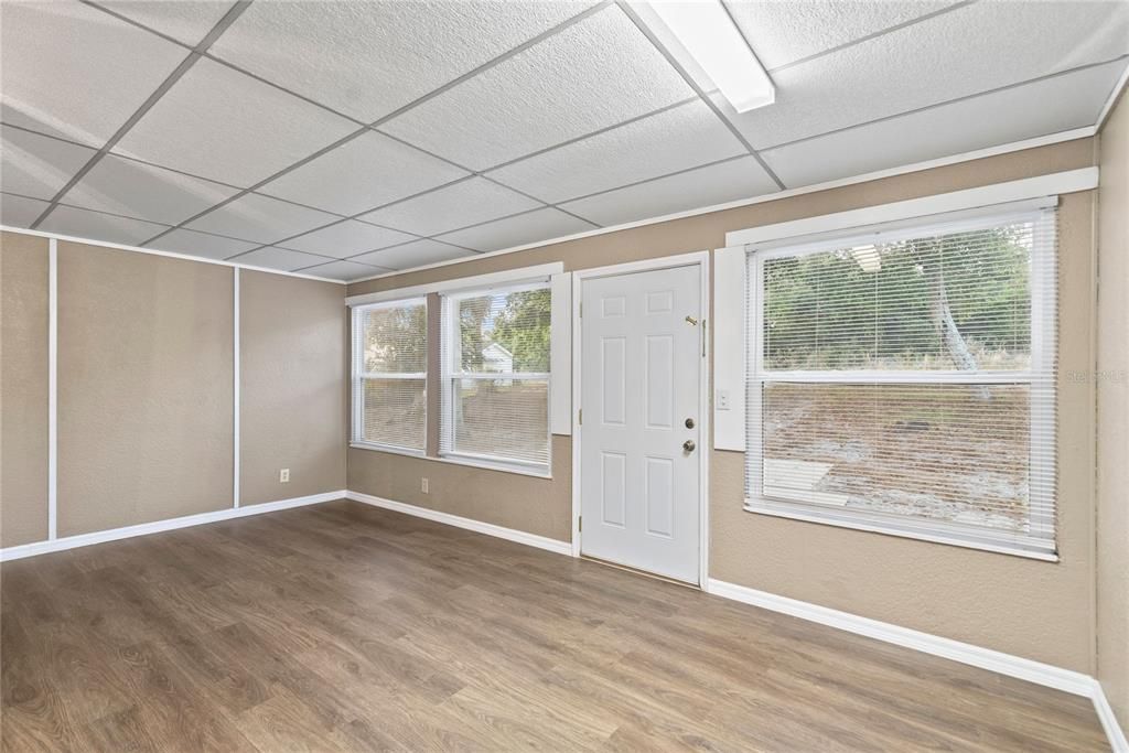 Bonus Room creates extra space to enjoy and features newly installed LVP flooring, overlooks oversized back yard and leads to brick paver patio.