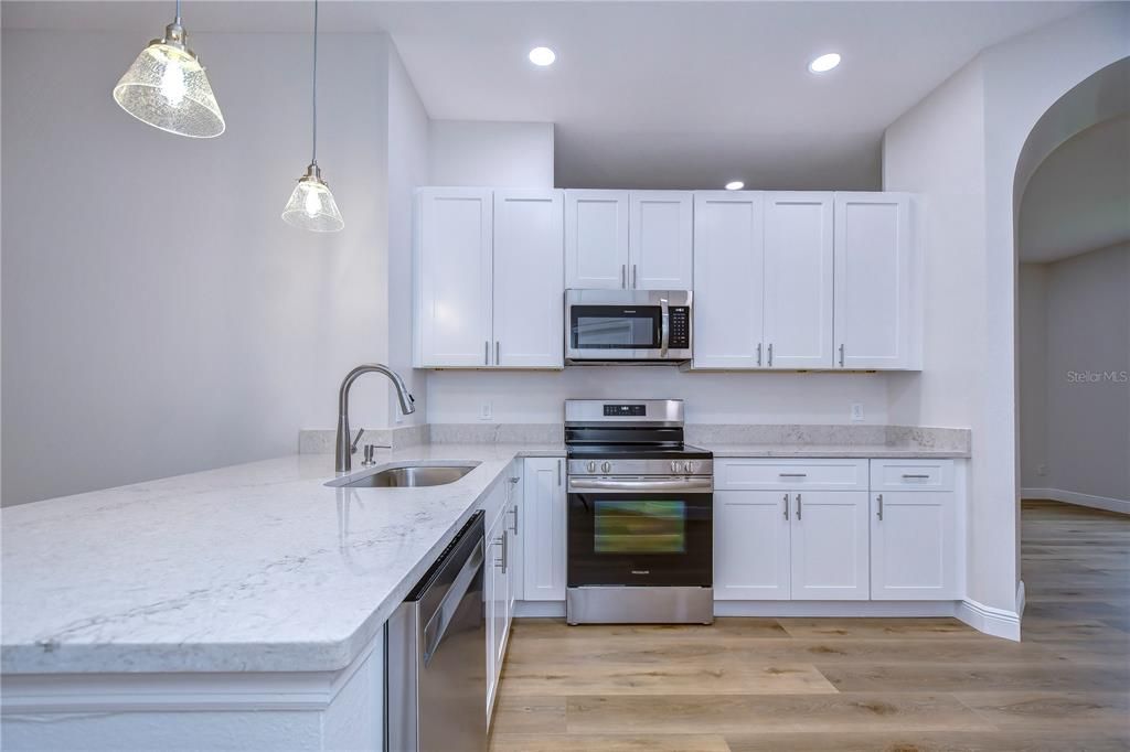 Amazing kitchen with quartz countertops, 42-in white cabinets, and stainless appliances!!