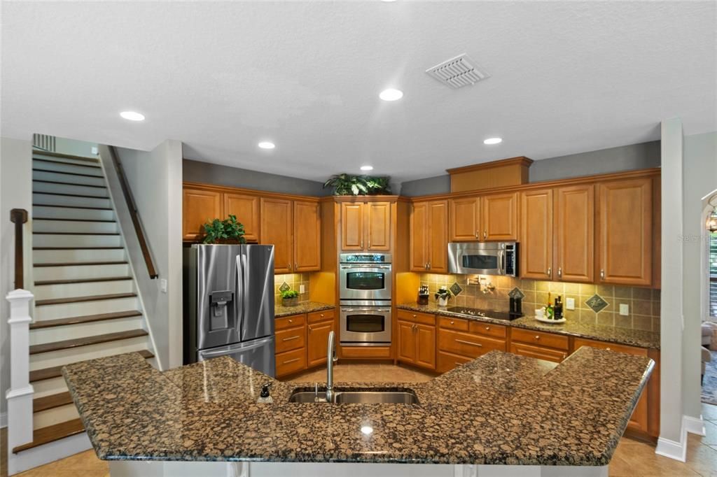 The kitchen features a double built in oven, pot filler and breakfast bar.