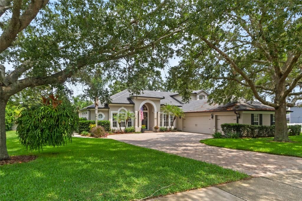 This home is situated on an oversized lot with expansive paver driveway and three car garage.