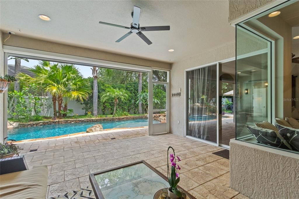 View of the covered lanai which features a retractable screen.