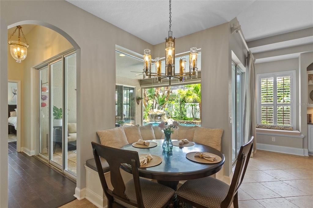 The kitchen features a cozy breakfast nook with aquarium glass windows.