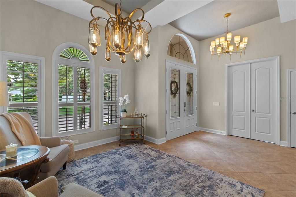 This home entrance features beautiful 8 ft double lead glass doors with custom lighting.