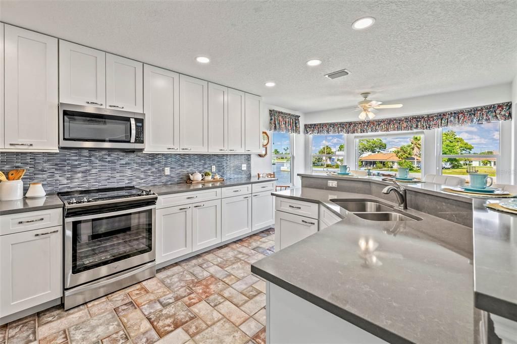 Remodeled kitchen with quartz countertoops and stainless steel appliances.