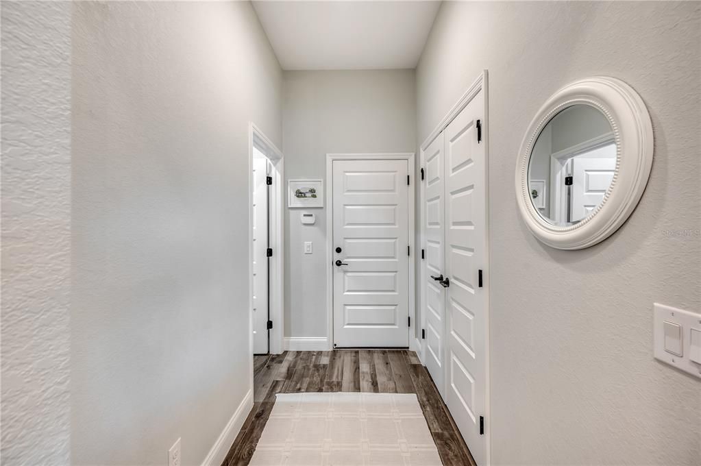 Hallway to laundry room and 3-car garage