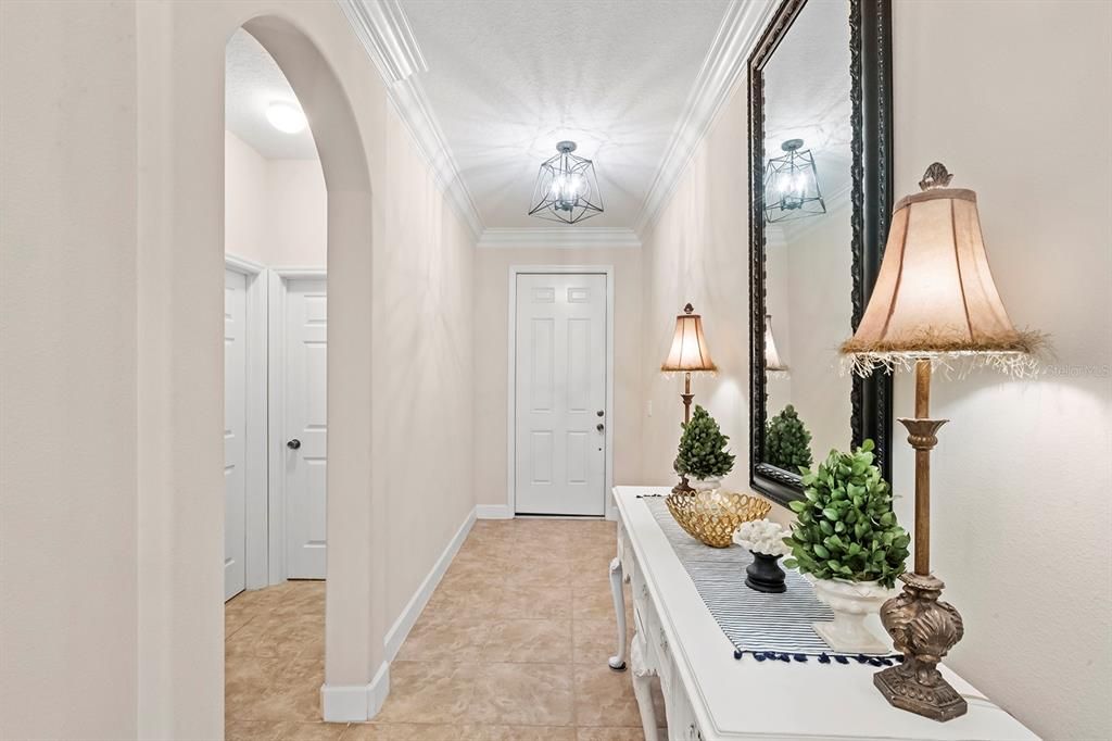 View to Front Door: Foyer, Ceramic Tile Crown Moulding