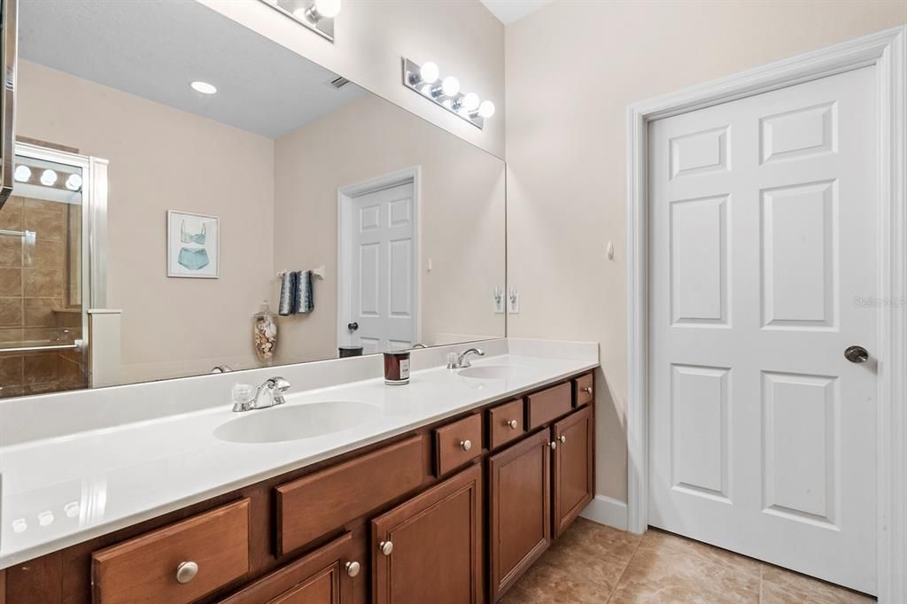 Master Bathroom: Double Sinks, ample storage and countertop space. Door to Walk-In Closet