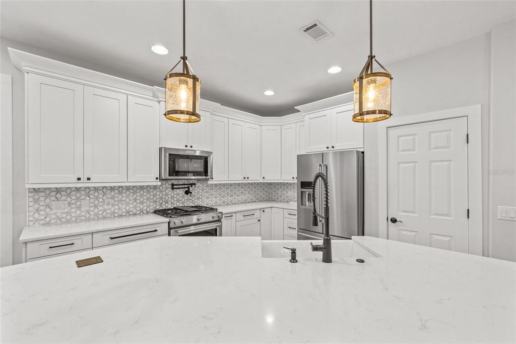 Beautiful quartz counters and marble backsplash ** Kitchen aid stainless steel gas range, microwave and refrigerator, Bosch dishwasher are included!