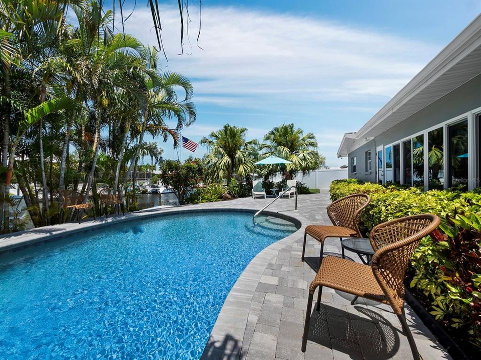 The backyard oasis is a tropical paradise with a gorgeous pool and a nice wide canal.