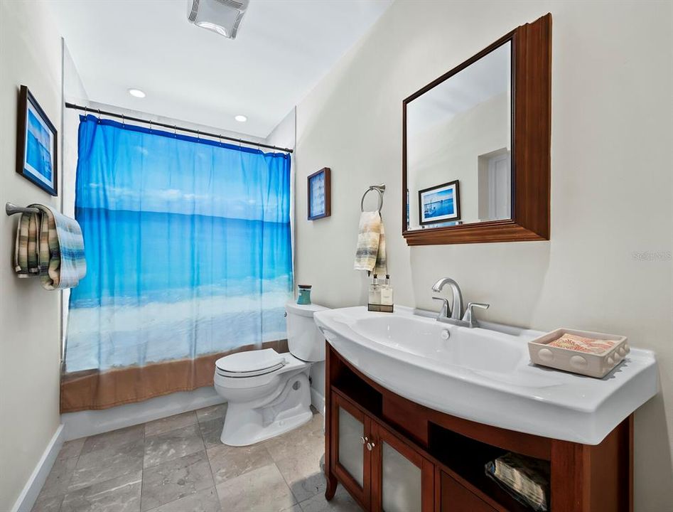 The bathroom just outside the 2nd bedroom also opens to the bonus room for perfect use when coming in from the pool.